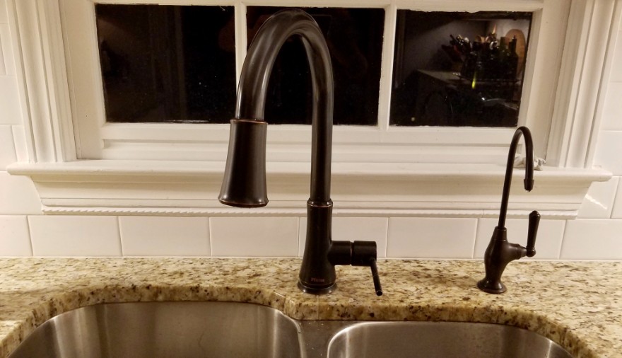 Pencil trim tile under kitchen sink backsplash