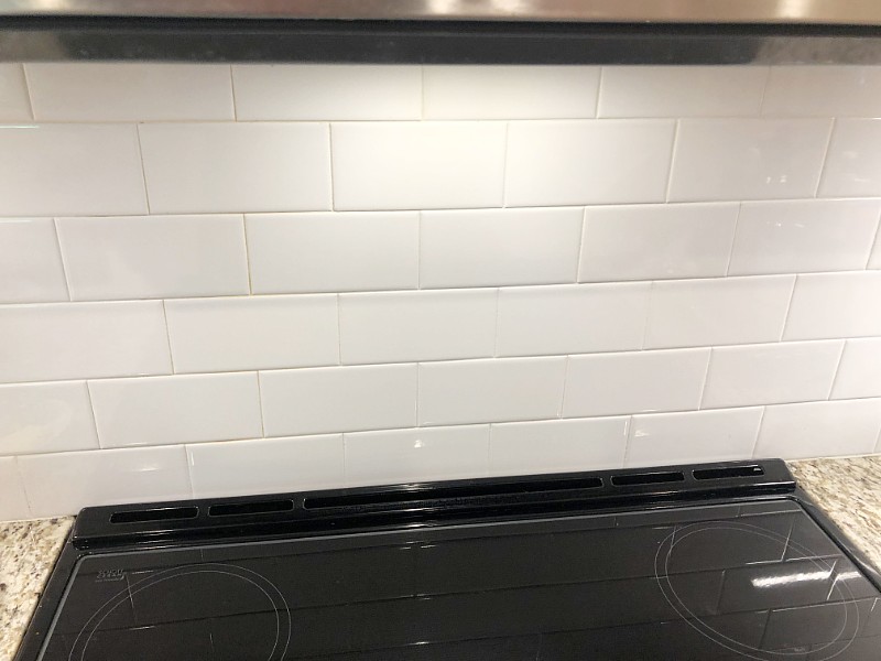 Plain subway tiles above kitchen stove