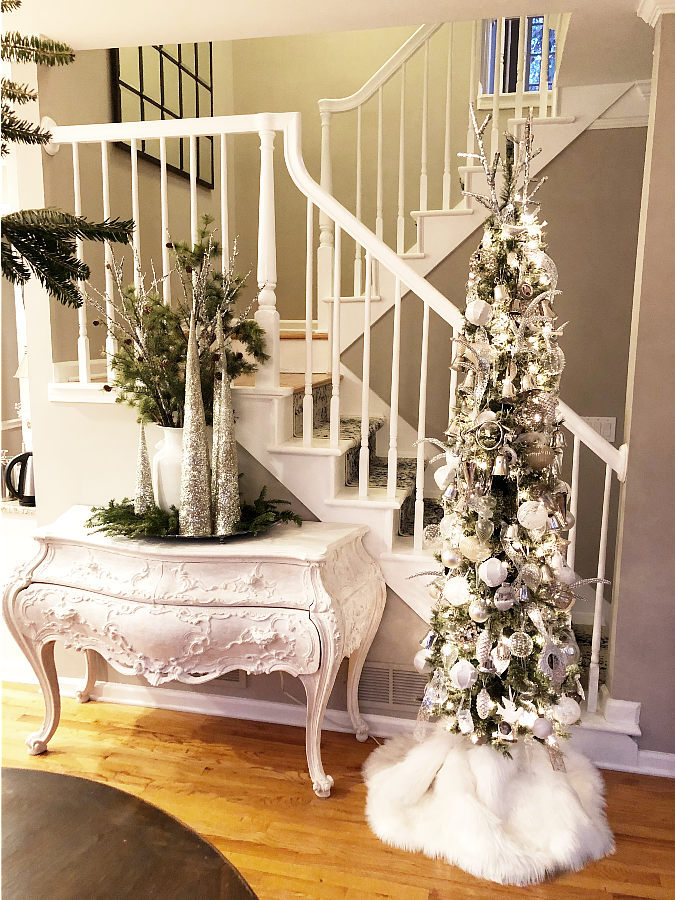 Winter white buffet and Christmas decor. Silver cone trees, fresh greens and glam.