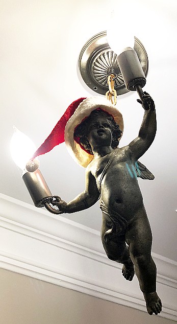 Angel chandelier with a santa hat
